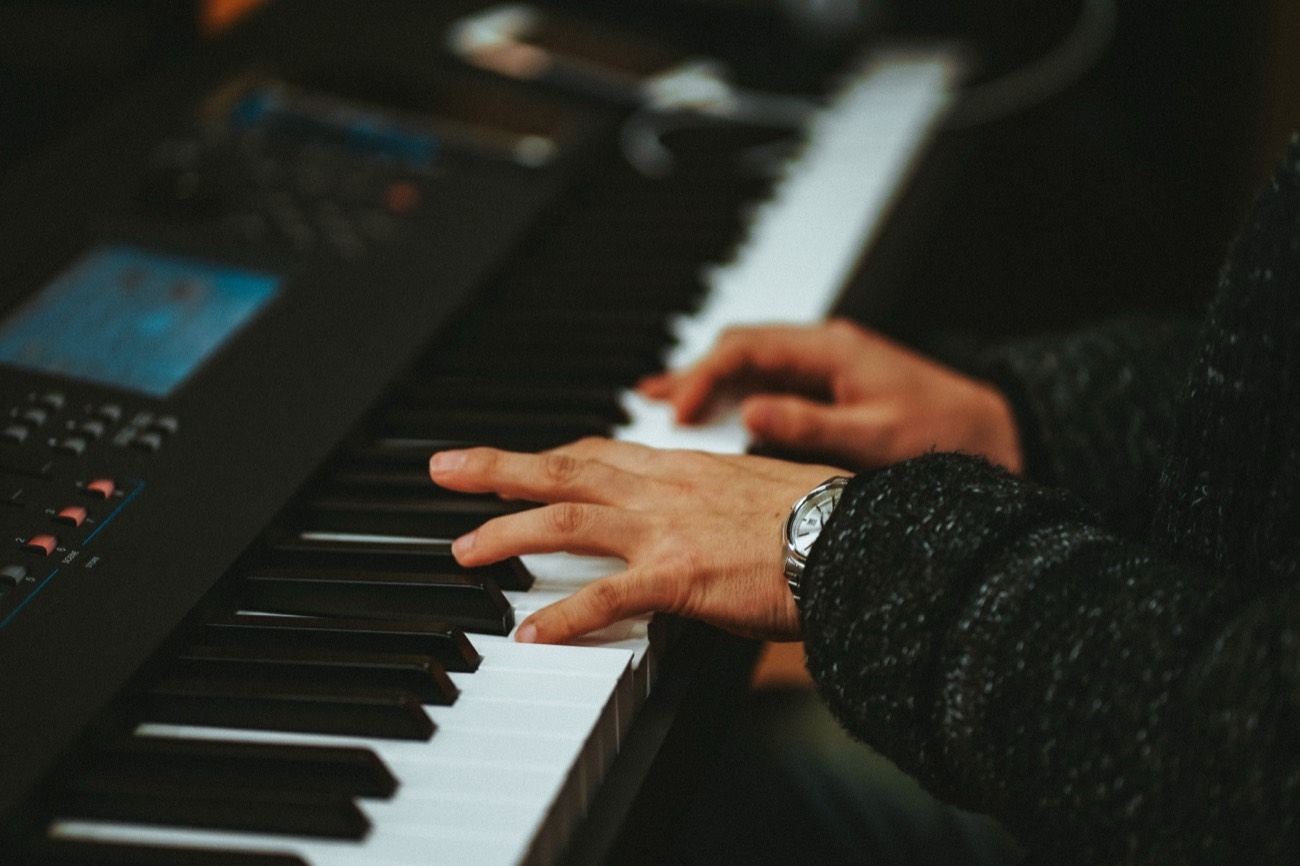 Hands playing keys in the studio