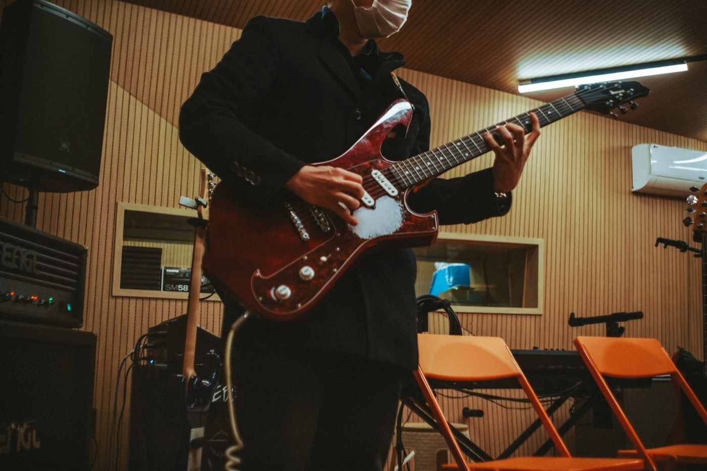 A guitarist mid-session in the live room