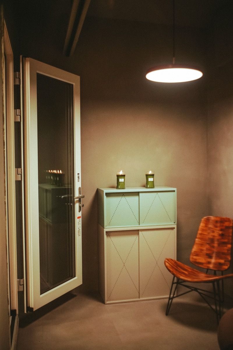 A warm corner with a glass door and a wooden chair