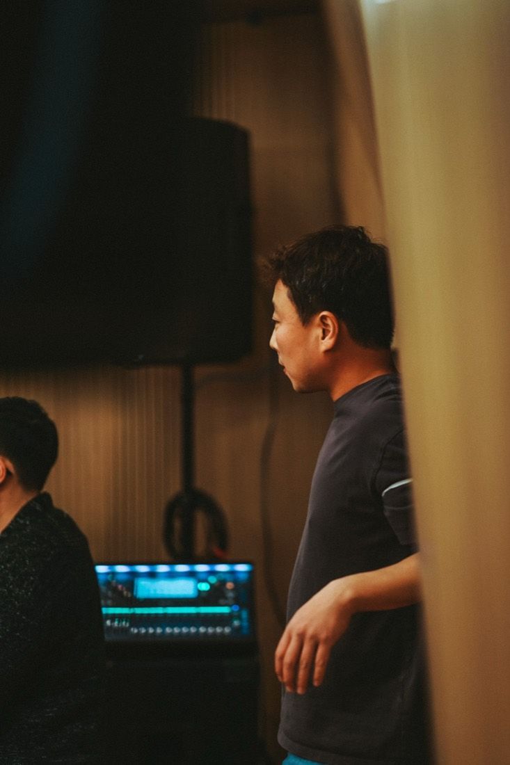 A musician in the control-room light